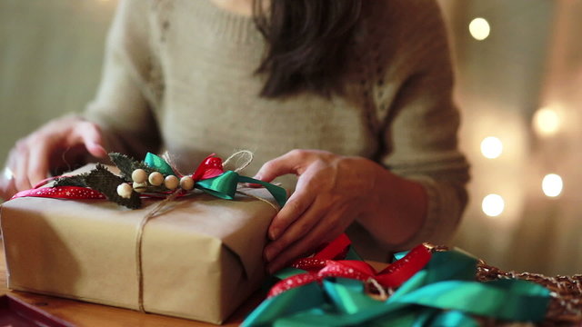 Women's Hands Wrapping Christmas Gifts At Home