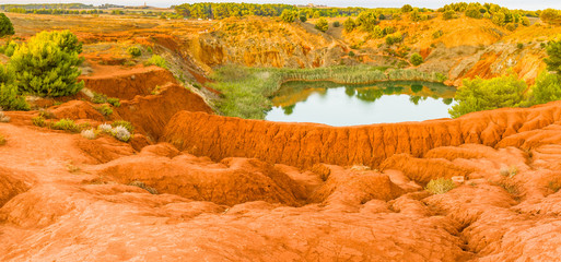 red soils around the lake in bauxite quarry