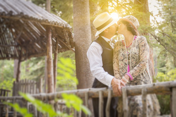 1920s Dressed Romantic Couple Kissing on Wooden Bridge