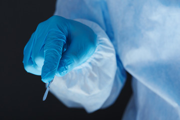 Fototapeta premium Surgeon hand holding surgical scalpel