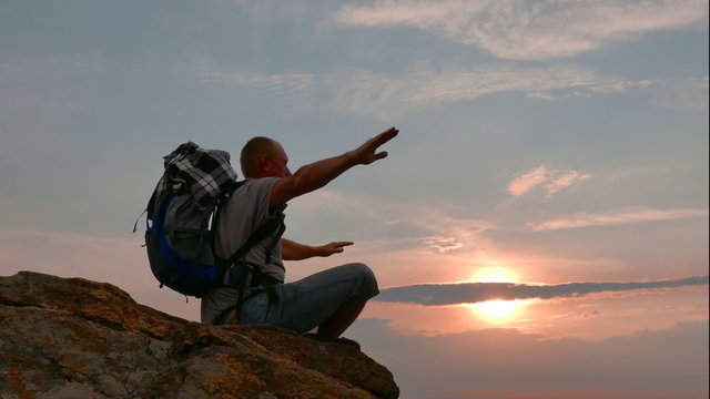 Silhouette of meditating man  tourist at sunrise time. 4K 3840x2160

