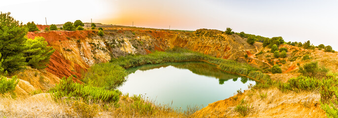 red soils around the lake in bauxite quarry