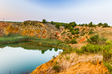 red soils around the lake in bauxite quarry