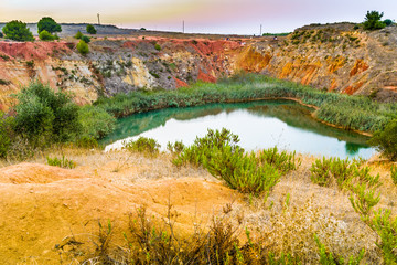 red soils around the lake in bauxite quarry