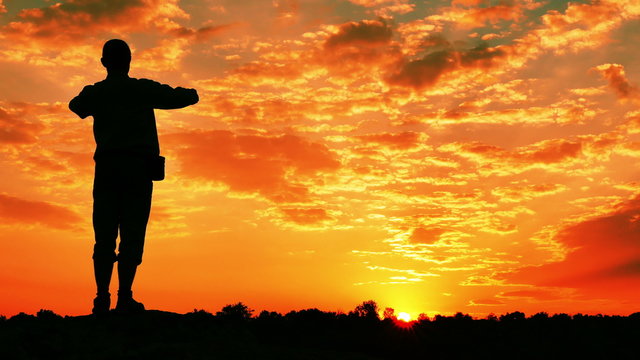 
Meditating man (prayer) at top with  raised hands  at  red sunrise, sunset. 4K 3840x2160. Scene1
