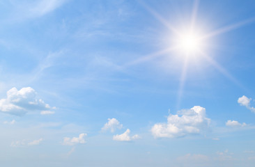 sun on blue sky with white clouds