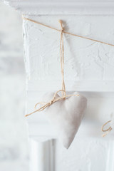 Handmade textile  white  heart  on a white background, rustic style. Romance consept.