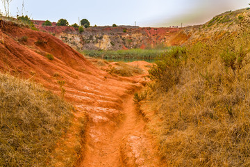 red soils around the lake in bauxite quarry