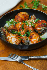 fried chicken drumsticks in a frying pan