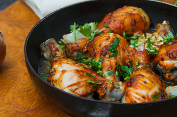 fried chicken drumsticks in a frying pan