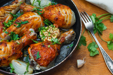 fried chicken drumsticks in a frying pan