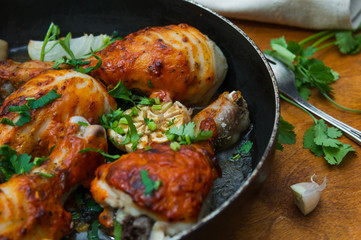 fried chicken drumsticks in a frying pan