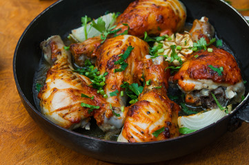 fried chicken drumsticks in a frying pan