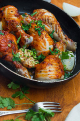 fried chicken drumsticks in a frying pan