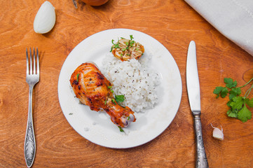 roasted chicken drumstick garnished with rice