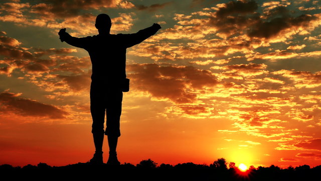 Meditating man (prayer) at top with  raised hands  at  red sunrise, sunset. 4K 3840x2160. Scene2