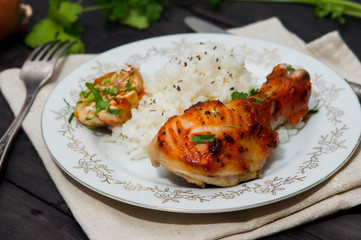 roasted chicken drumstick garnished with rice