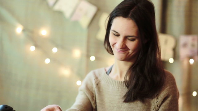 Young Woman Wrapping Christmas Gifts At Home