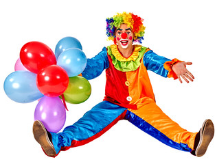 Happy birthday clown holding a bunch of balloons and sitting on floor