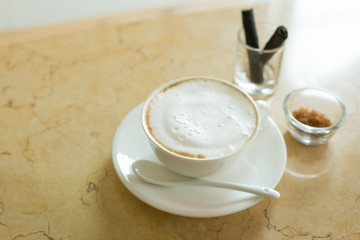 Hot art Latte Coffee in a cup on wooden table and Coffee shop bl