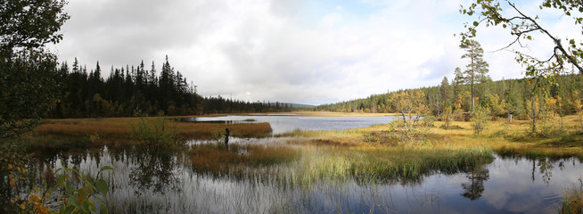 Panoramic view of Myrflodammen near Saelen, Sweden. A shot on a rainy and sunny day were made from the same viewpoint and stitched together