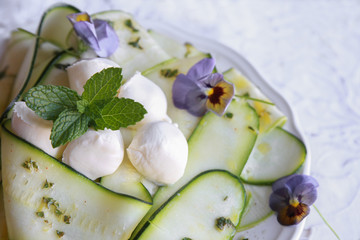 Edible flowers and Zucchini courgette salad, selective focus