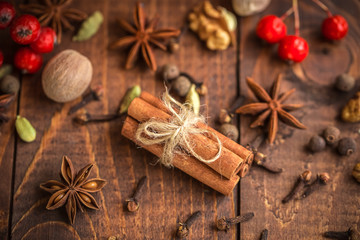 Collection of spices for mulled wine and pastry on the wooden table