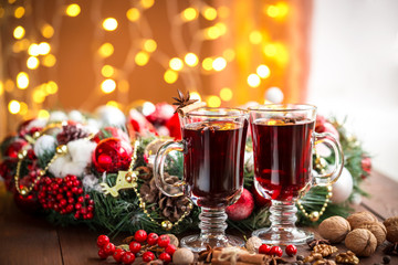 Christmas hot mulled wine with spices on a wooden table. The idea for creating greeting cards