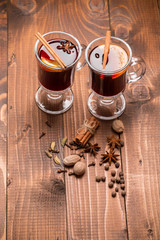 Christmas hot mulled wine with spices on a wooden table. The idea for creating greeting cards