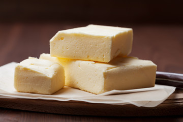 Stick of butter on wooden cutting board