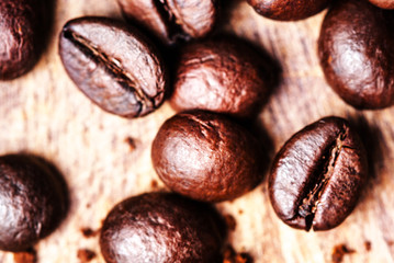 Coffee beans on macro ground coffee background, top view image.