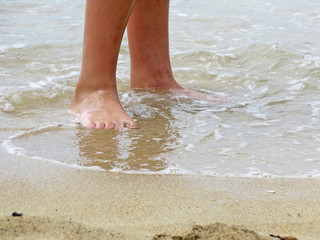 Sandy beach closeup with wave in Mallorca, Balearic islands, Spain.