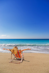 Fototapeta na wymiar Woman on a sun lounger at the beach