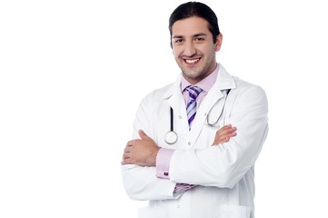 Fototapeta premium Young smiling confident male doctor posing