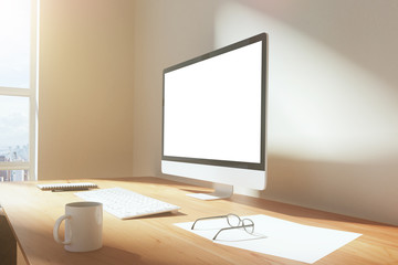 Blank screen of monitor with cup of coffee, glasses and keyboard