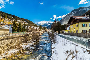 river through snowy alpine village