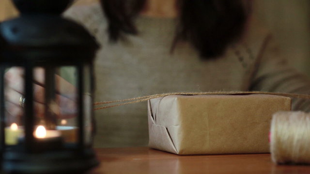 Women's Hands Wrapping Christmas Gifts At Home