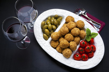 healthy italian appetizer with risotto balls arancini , green ol