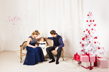 Christmas Family Portrait In Home Holiday Living Room, Kid With Present Gift Box, House with Xmas Tree