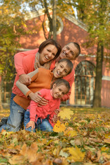 Family relaxing in autumn park