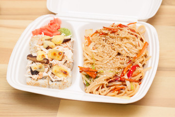 Chinese noodles and Japanese rolls in box
