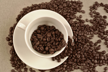 sepia vintage background with white cup and coffee beans