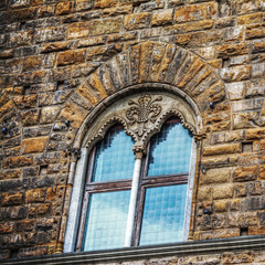Fototapeta na wymiar windows in a grunge brick wall in Florence