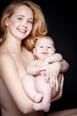 Happy mother with newborn on hands 