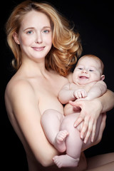 Happy mother with newborn on hands 