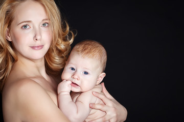 Happy mother with newborn on hands 