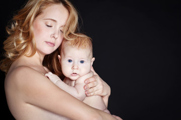 Happy mother with newborn on hands 