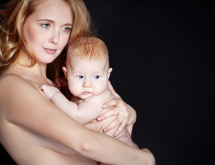 Happy mother with newborn on hands 