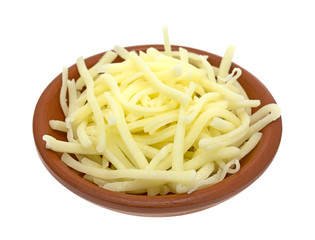 Portion of natural white mild cheddar cheese in bowl