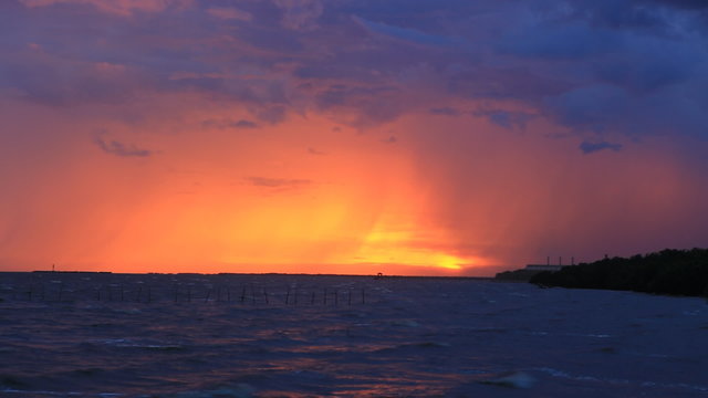 Storm with sunset in evening light on the beach